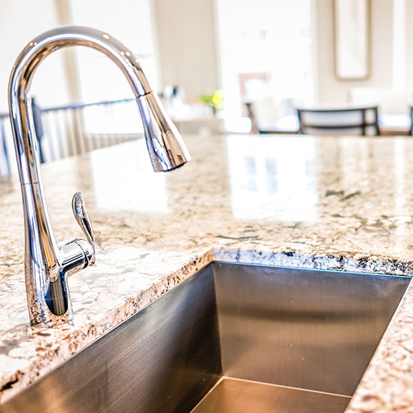 New modern faucet and kitchen room sink closeup